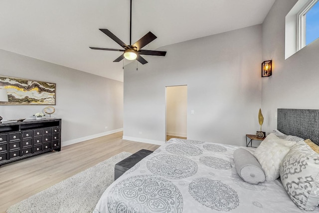 bedroom featuring ceiling fan, vaulted ceiling, and light hardwood / wood-style flooring