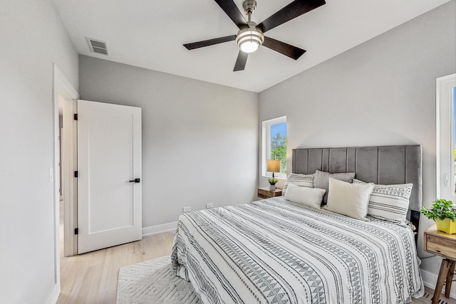 bedroom with light hardwood / wood-style flooring and ceiling fan