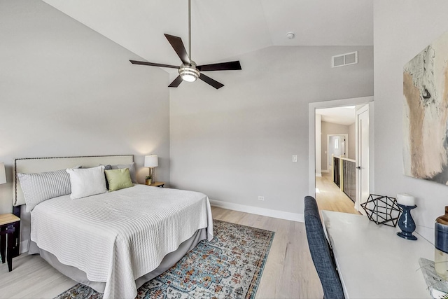 bedroom with vaulted ceiling, light hardwood / wood-style floors, and ceiling fan