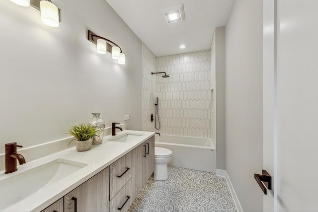 full bathroom with vanity, tiled shower / bath, tile patterned floors, and toilet