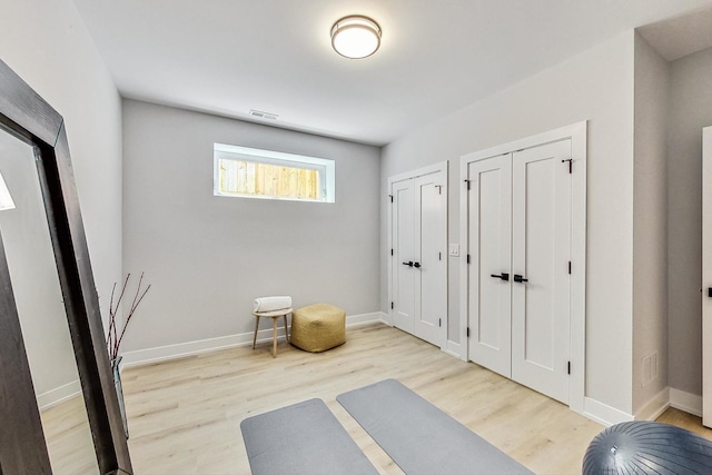 exercise area featuring light hardwood / wood-style floors