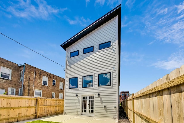 rear view of house featuring a patio area and french doors