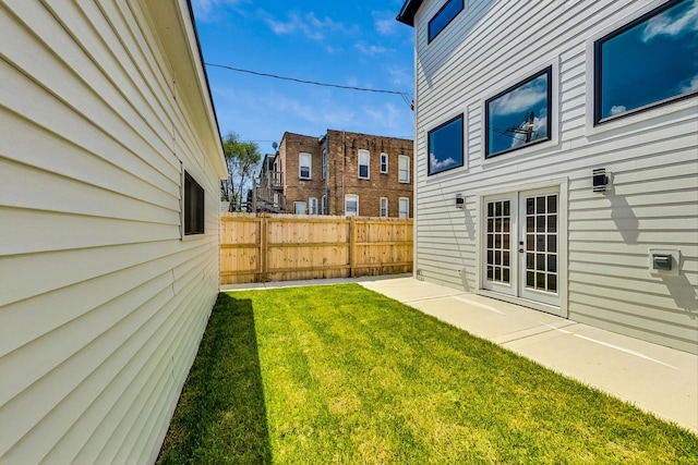 view of yard with a patio area and french doors