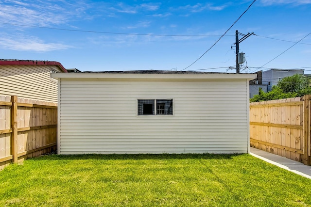 view of outbuilding with a yard