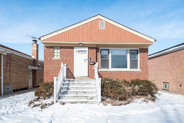 bungalow with entry steps and brick siding