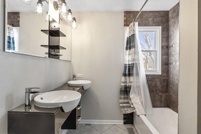 full bathroom with shower / bathtub combination with curtain, baseboards, a sink, and tile patterned floors