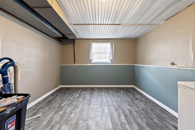 basement with baseboards and wood finished floors