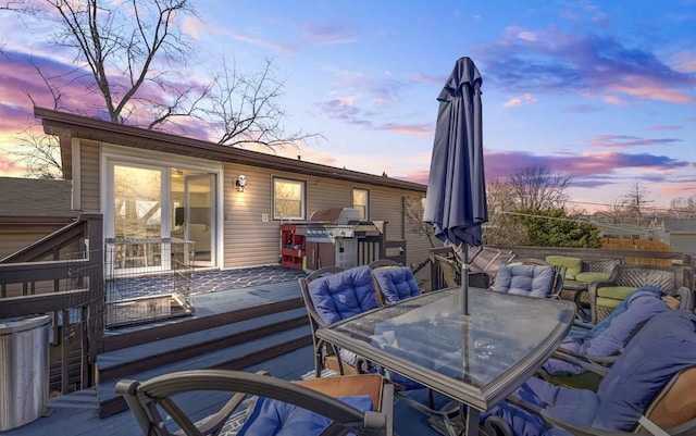 wooden terrace with outdoor dining area and a grill