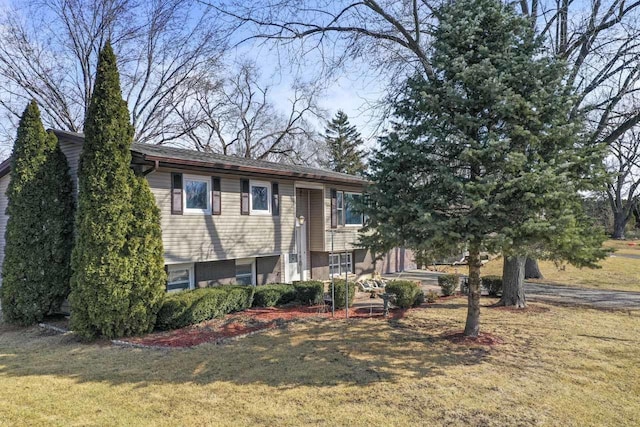 raised ranch featuring a front lawn