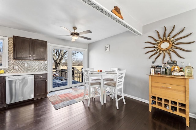 dining space with dark wood-style floors, ceiling fan, and baseboards