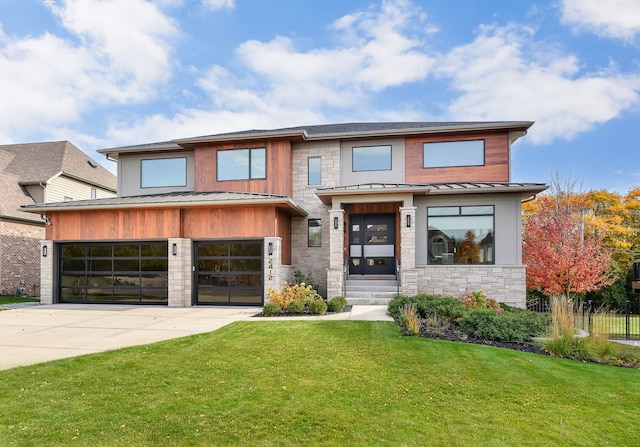 view of front of home with a garage and a front lawn