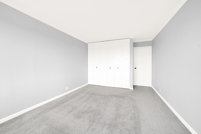 unfurnished bedroom with carpet floors and a closet