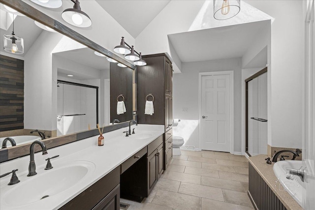 bathroom with a shower stall, lofted ceiling, a garden tub, and a sink