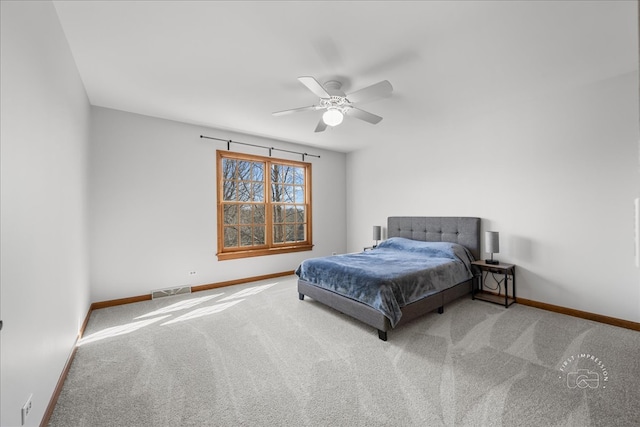 carpeted bedroom with a ceiling fan, visible vents, and baseboards