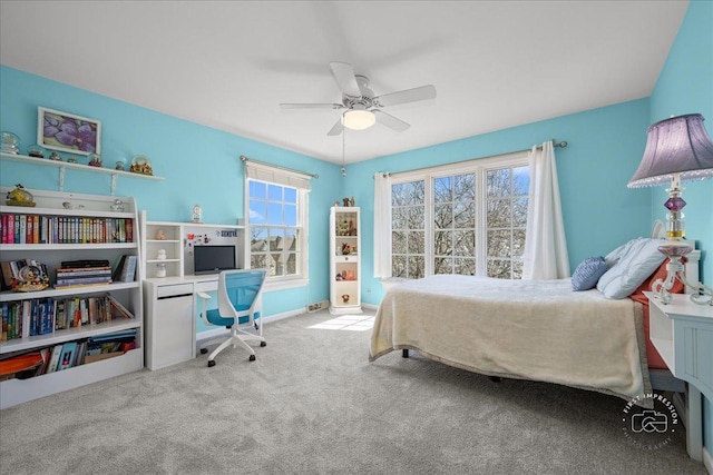 carpeted bedroom with a ceiling fan and baseboards