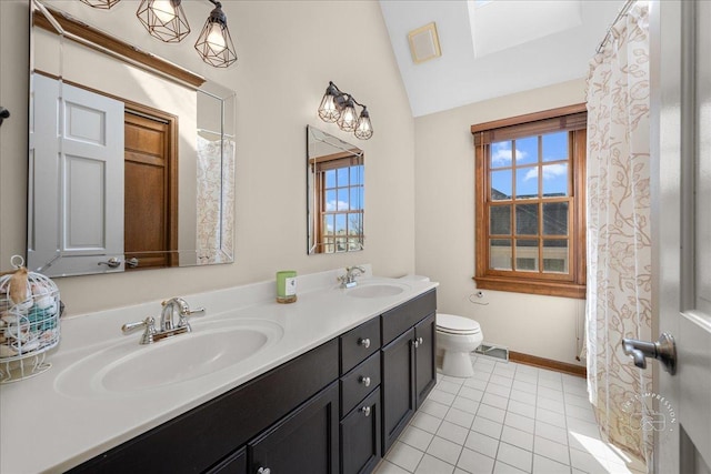 bathroom with lofted ceiling, toilet, visible vents, and a sink