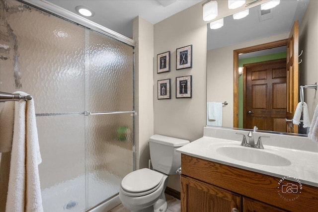 bathroom with vanity, visible vents, a stall shower, tile patterned floors, and toilet