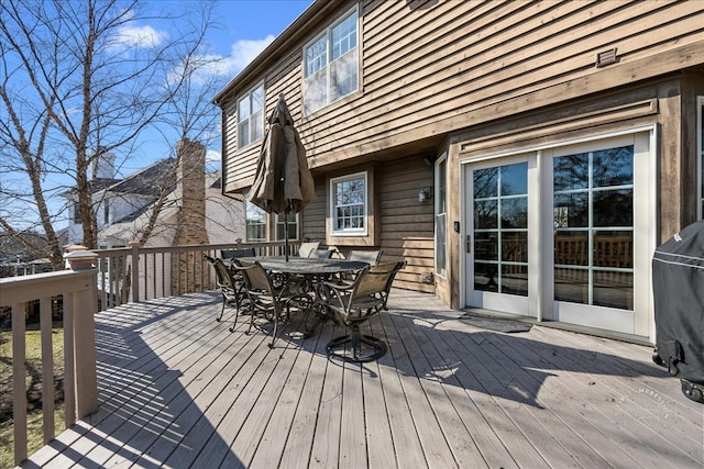 wooden deck featuring outdoor dining area