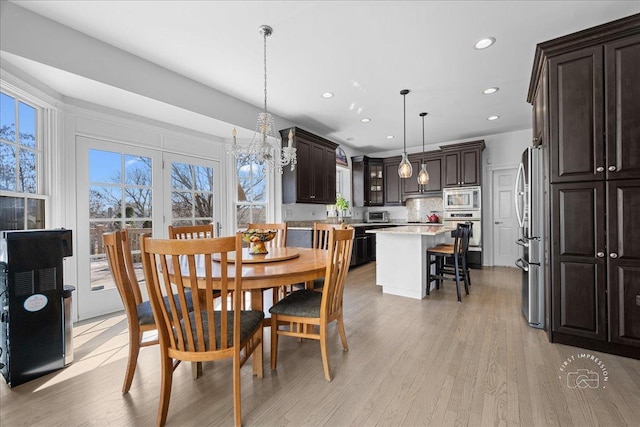 dining space featuring light wood-style flooring and recessed lighting