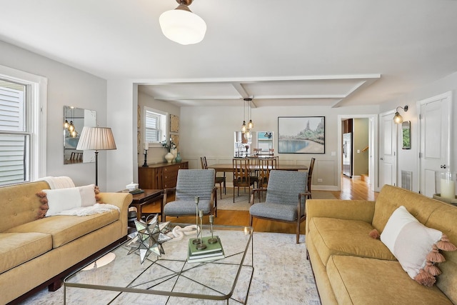 living room with light wood finished floors and visible vents