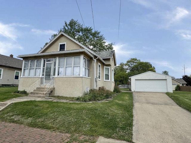 1313 Porter Ave, Lasalle, IL 61301 - bungalow with stucco siding, entry steps, a detached garage, and a front yard