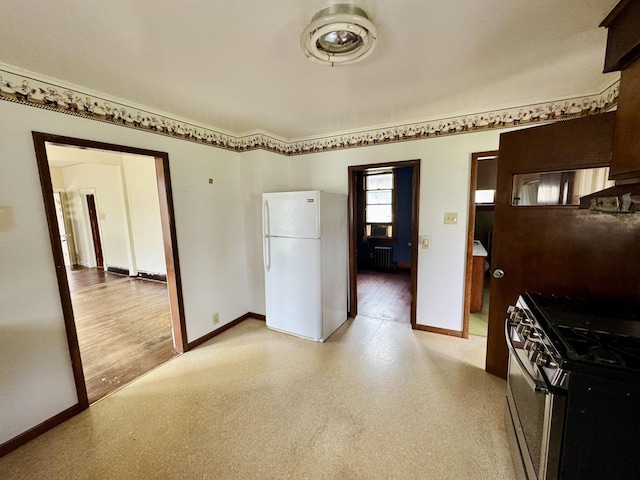1313 Porter Ave, Lasalle, IL 61301 - kitchen with stainless steel range with gas stovetop, freestanding refrigerator, baseboards, and radiator heating unit
