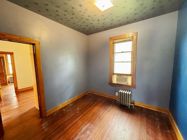 1313 Porter Ave, Lasalle, IL 61301 - empty room featuring radiator, hardwood / wood-style floors, baseboards, cooling unit, and lofted ceiling