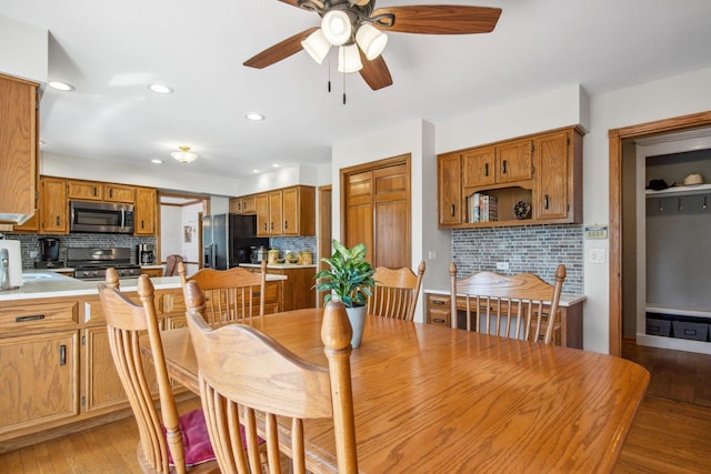 dining area with a ceiling fan, recessed lighting, and light wood finished floors