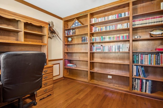 office space with ornamental molding and wood finished floors