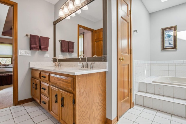 ensuite bathroom with double vanity, ensuite bath, a sink, and tile patterned floors