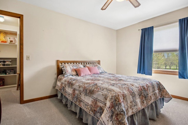 bedroom featuring a ceiling fan, baseboards, and carpet flooring