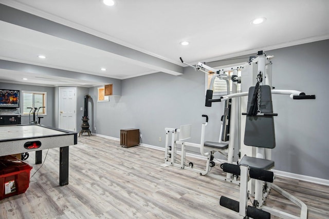 exercise room with recessed lighting, baseboards, wood finished floors, and ornamental molding