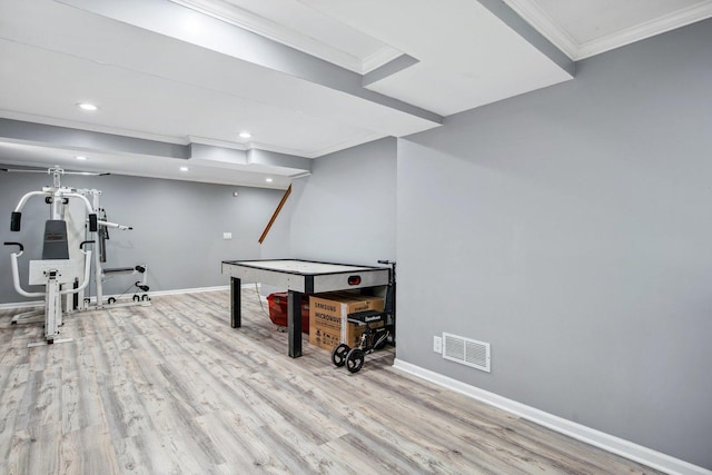 game room featuring ornamental molding, visible vents, baseboards, and wood finished floors