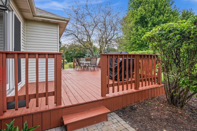 wooden terrace with outdoor dining area