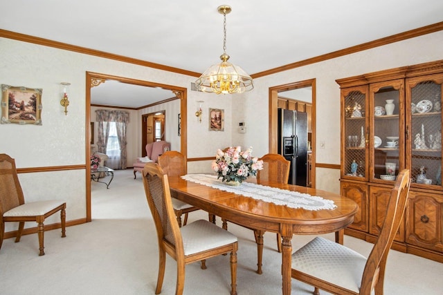 dining area with a chandelier, ornamental molding, and light colored carpet