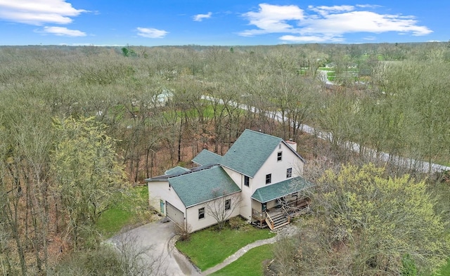 aerial view of property and surrounding area with a forest