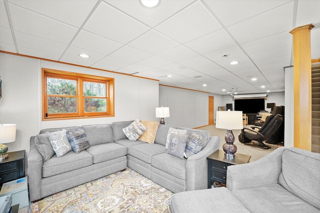 living area with recessed lighting, a drop ceiling, and ornamental molding