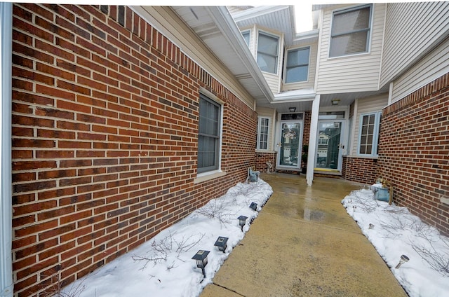 view of snow covered property entrance