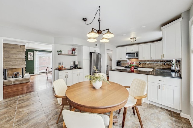 dining space featuring a stone fireplace