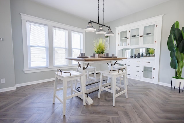 dining space featuring light parquet floors