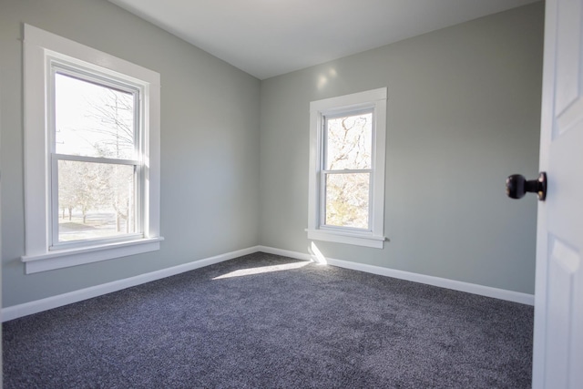 empty room featuring dark carpet