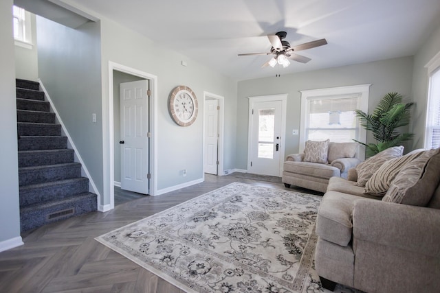 living room with ceiling fan and dark parquet flooring