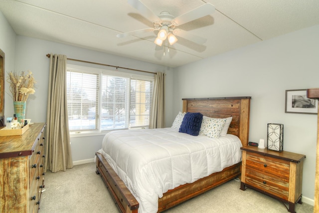 bedroom featuring light colored carpet and ceiling fan