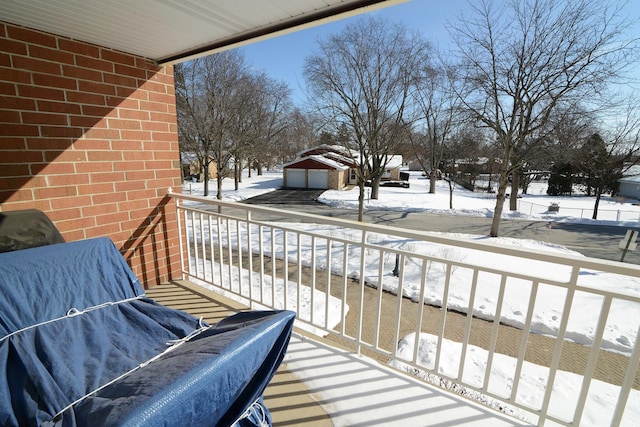 view of snow covered back of property