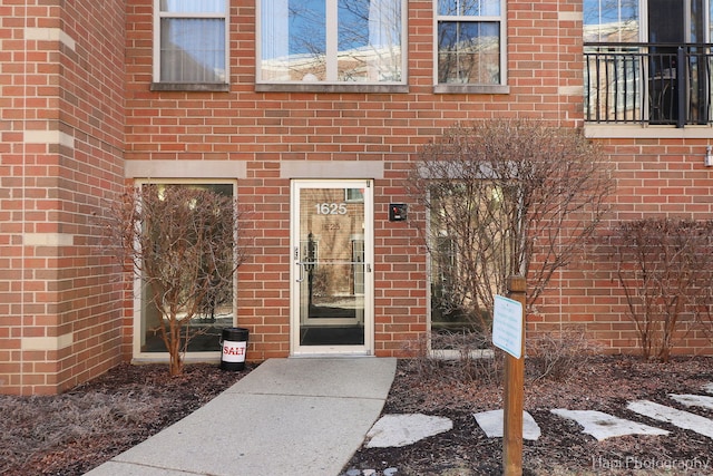 property entrance featuring brick siding