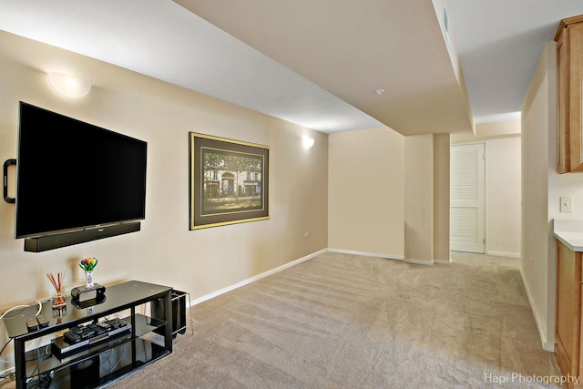 interior space with light carpet and baseboards