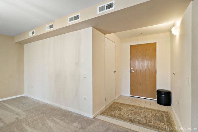 interior space featuring baseboards and visible vents