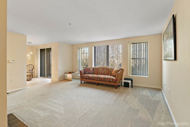 carpeted living room with baseboards