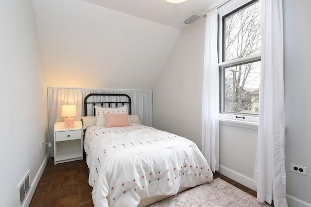 bedroom with vaulted ceiling, visible vents, and baseboards