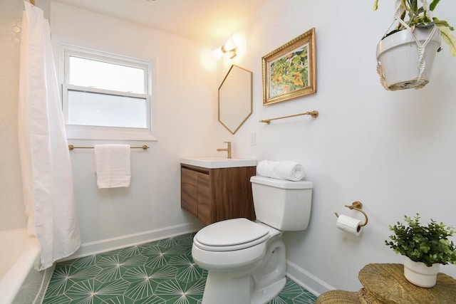 bathroom with baseboards, vanity, and toilet